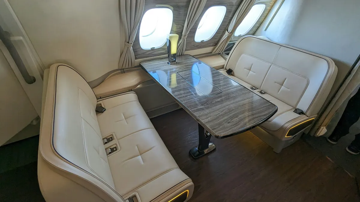 Club seating around a polished table in a private jet cabin