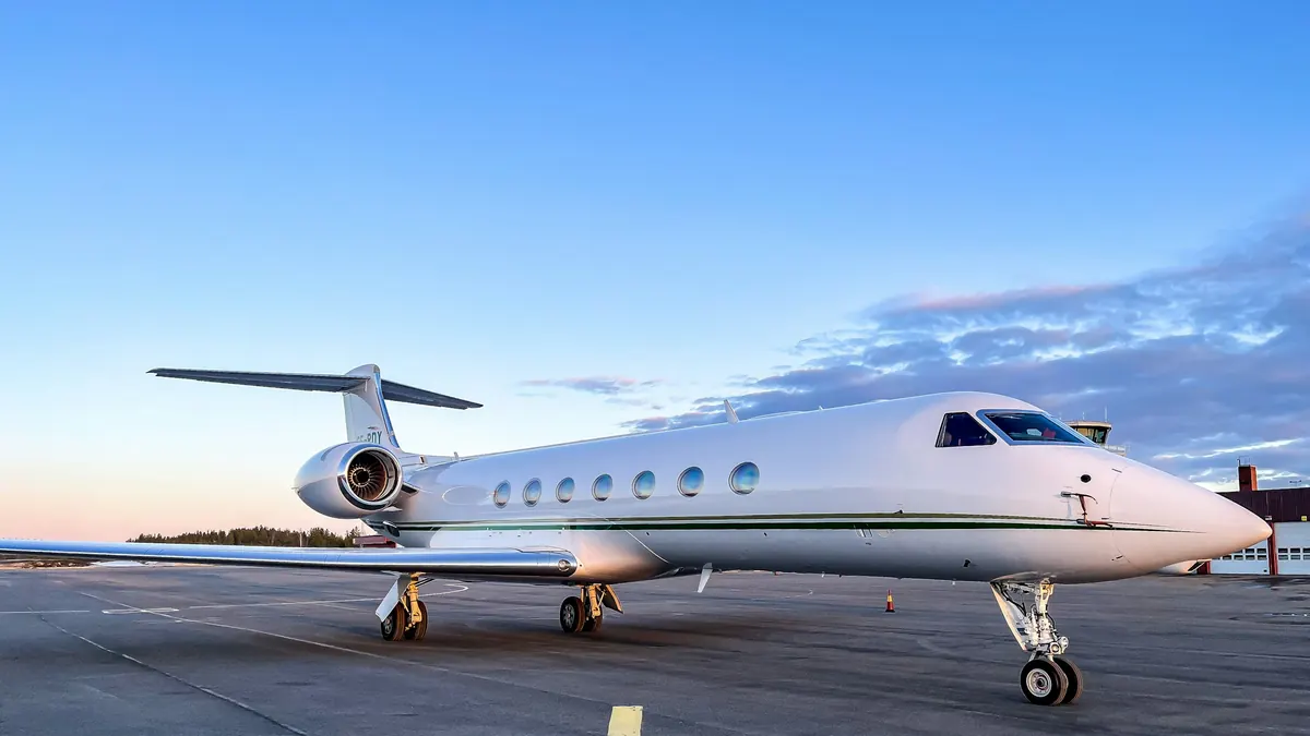 Gulfstream business jet parked on a sunlit ramp