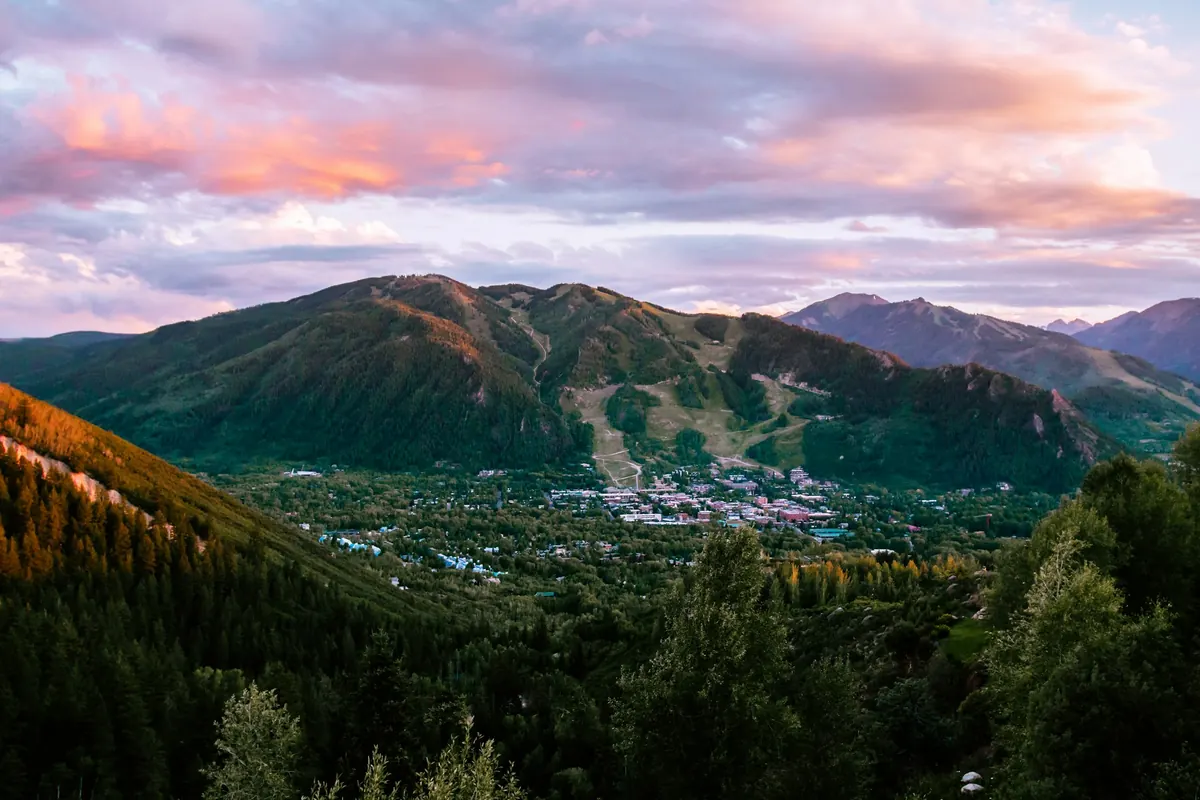 Aspen town at sunset below the mountains