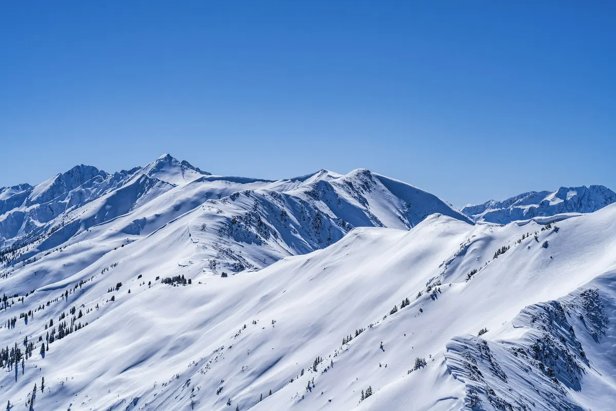 Snow-covered mountain peaks under a clear sky